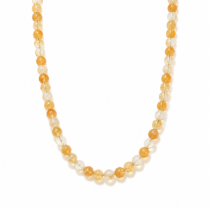A beaded necklace made of translucent round beads in warm amber orange and clear white, arranged in a U-shape on a plain white background.